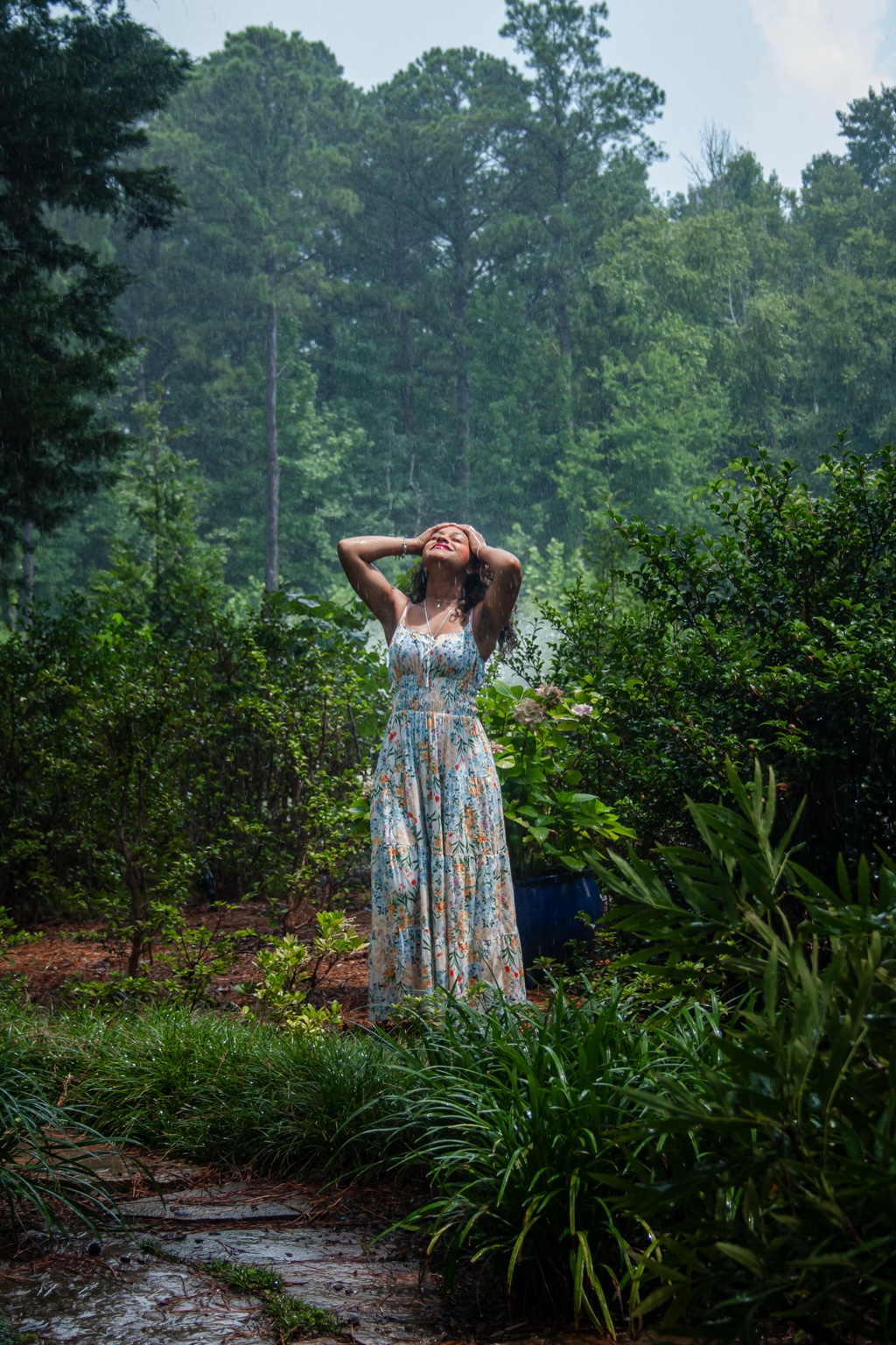 Portrait photographed in a lush garden during rainfall