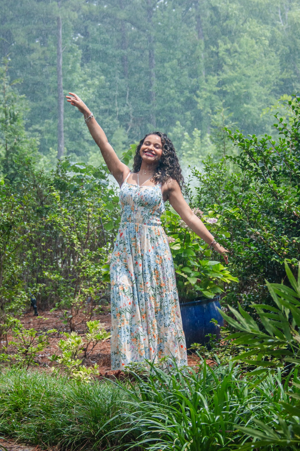 Rain portrait with arms outstretched