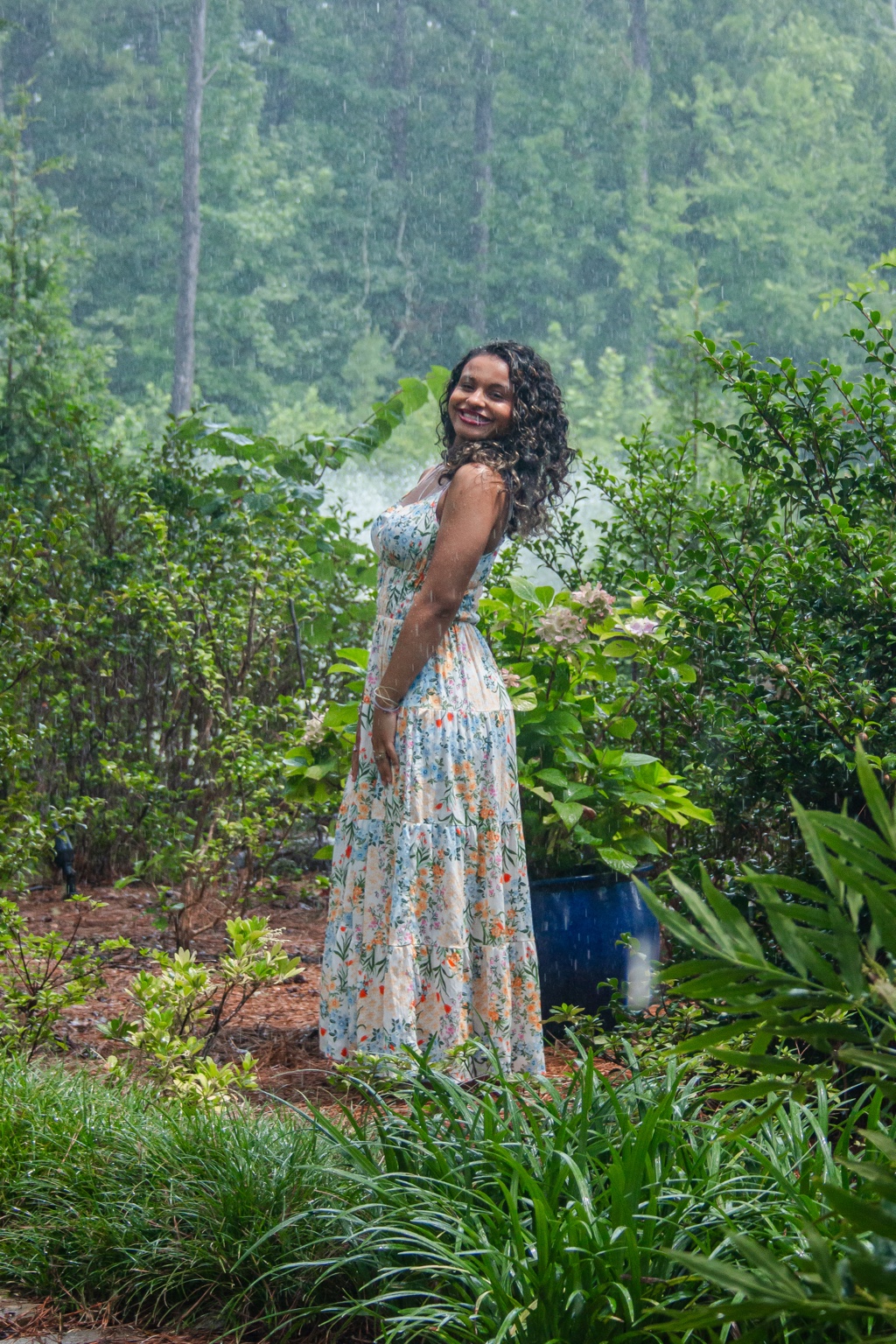Smiling portrait in a rain-soaked garden