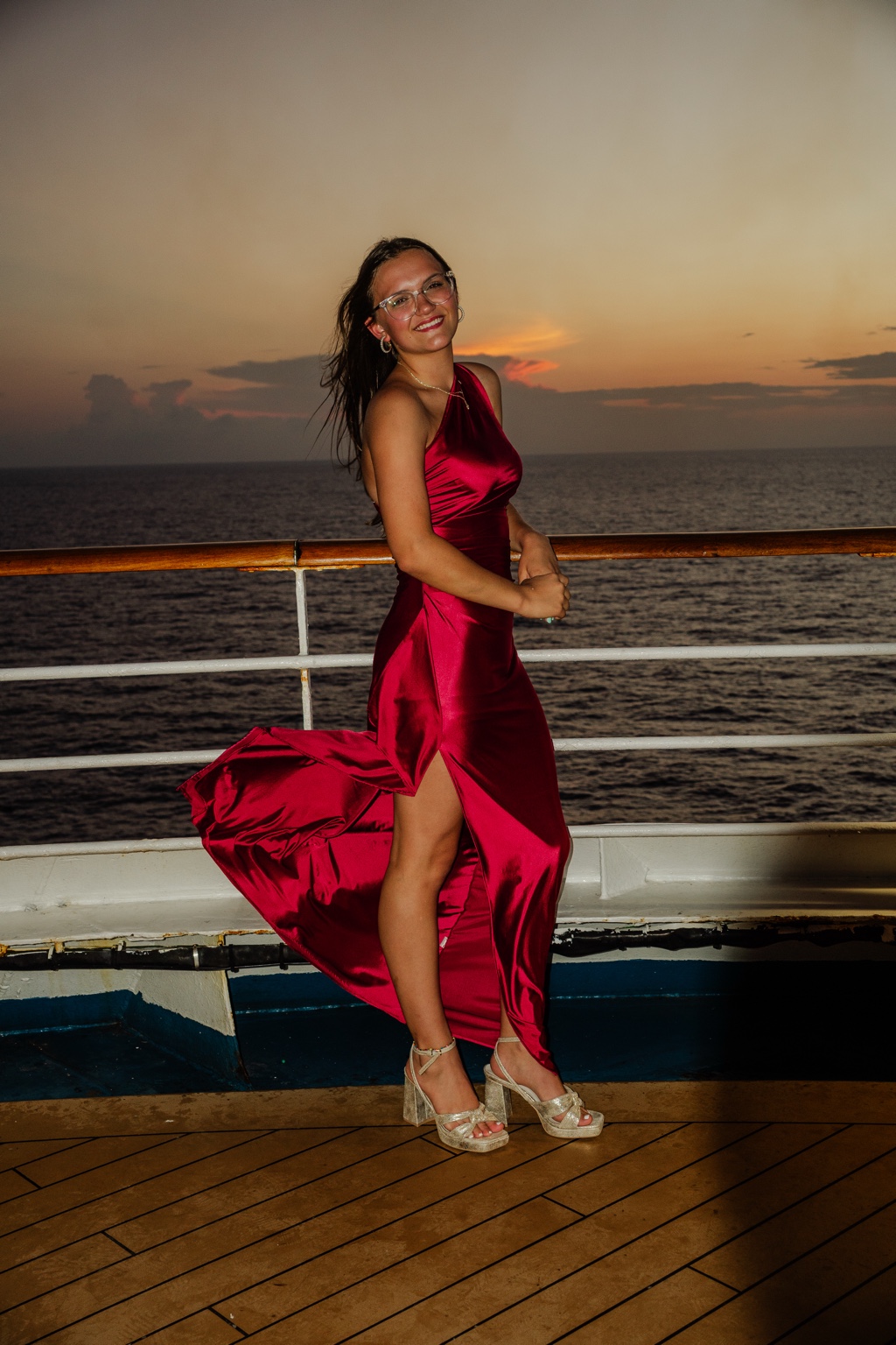 Full-body portrait in a red dress at sunset