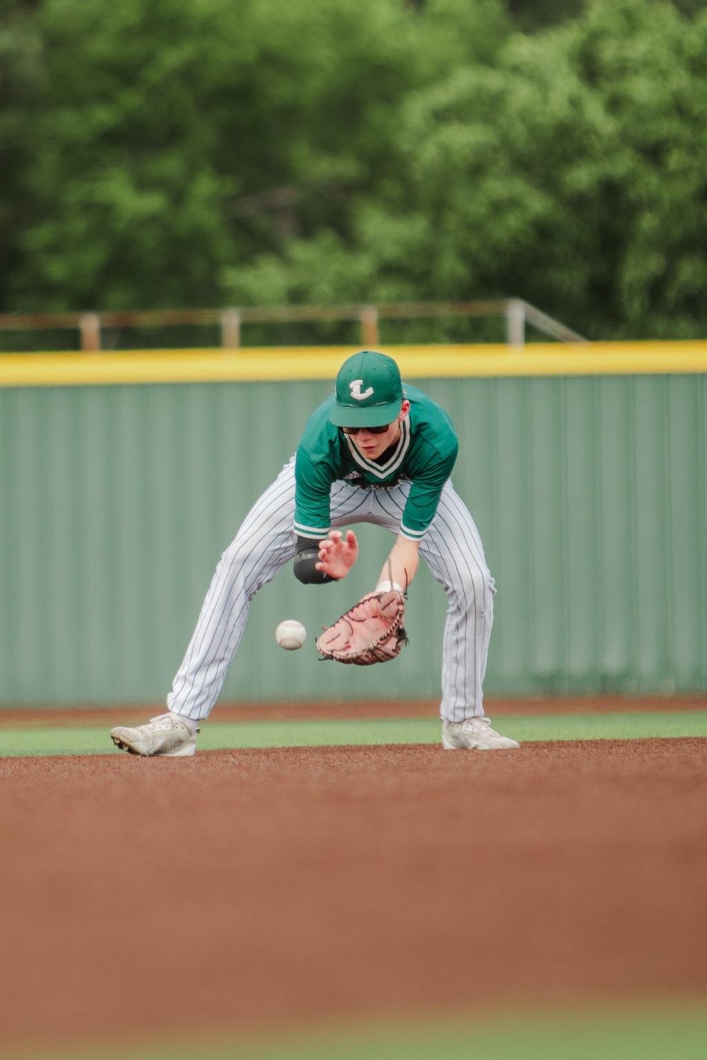 Infielder reaching for a ground ball
