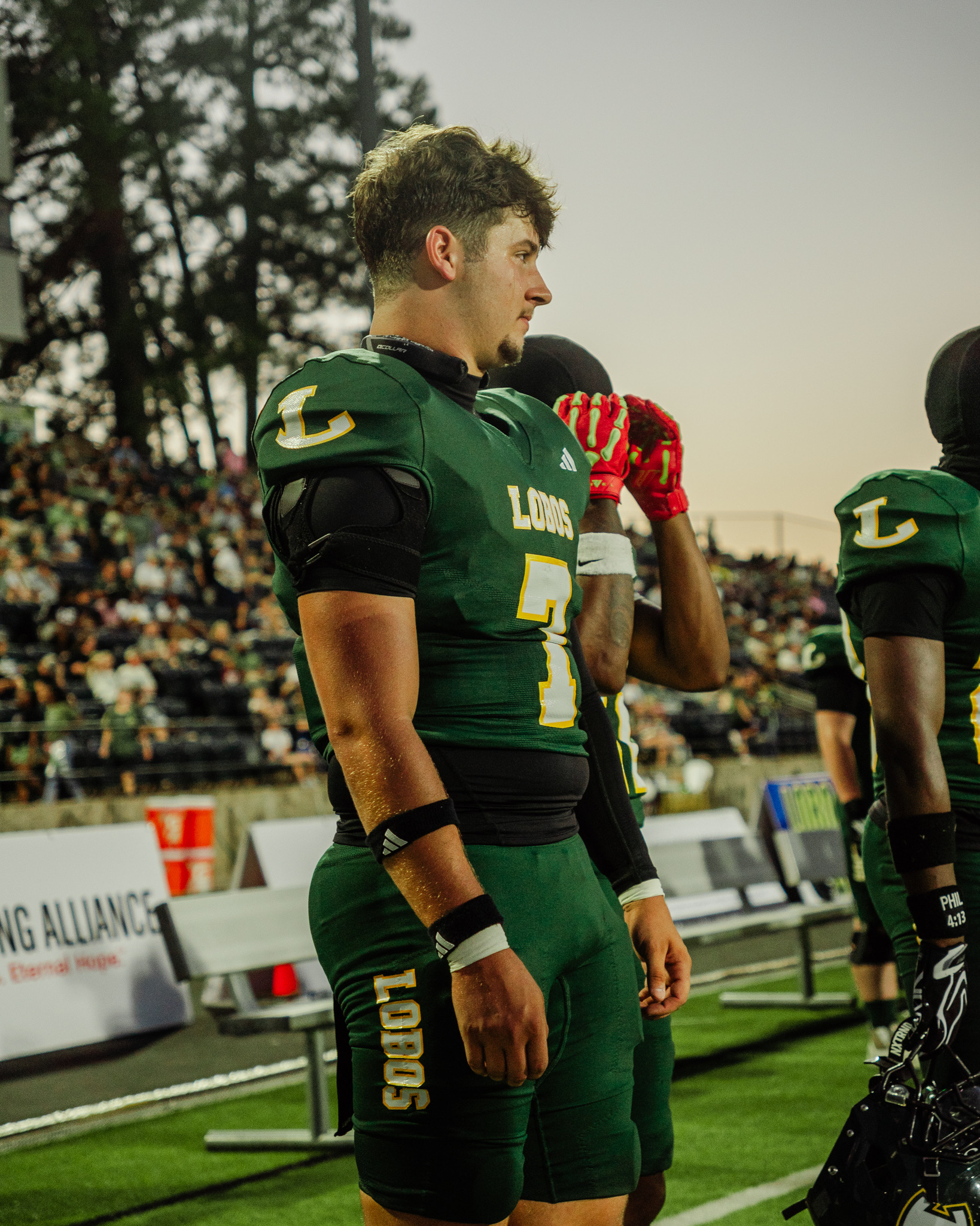 Side-profile portrait of Longview player number 7 in warm evening light