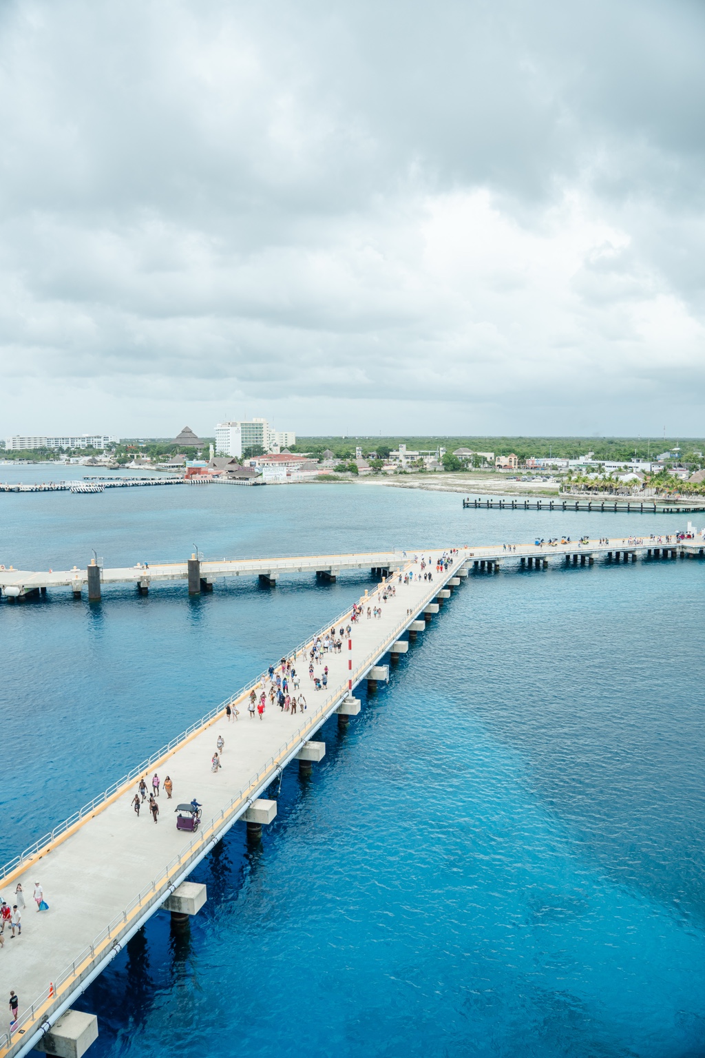 Long pier over clear blue water